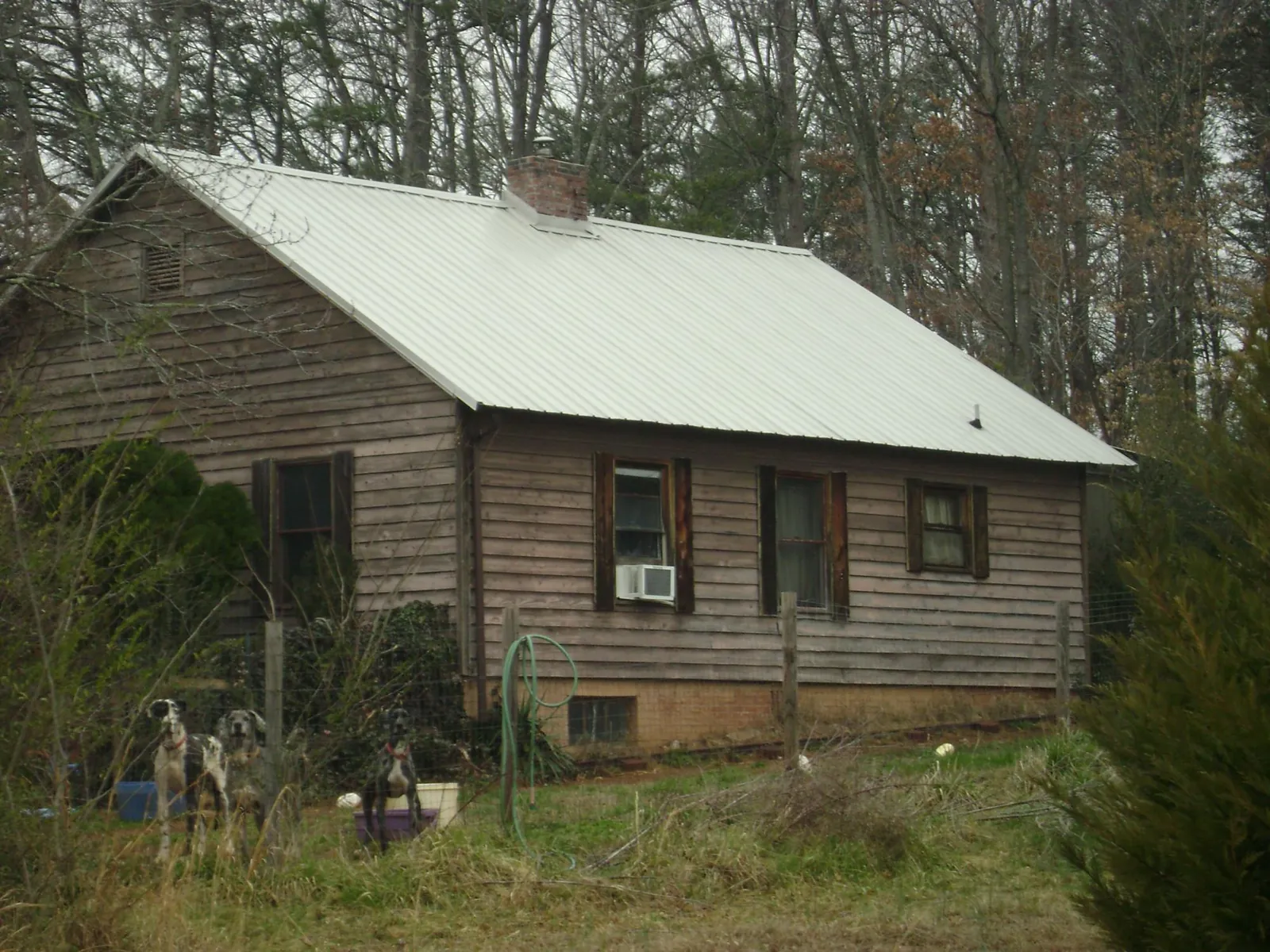 White metal roof on an old wood sided farmhouse, from a Metal Roof Installation job in Ruffs Dale
